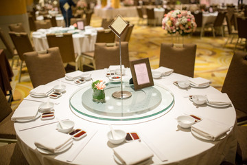 wedding table sets in wedding hall. wedding decorate preparation. table set and another catered event dinner, luxury wedding table setting for fine dining at indoors.