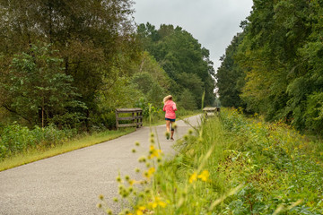 Woman Jogging on Paved Nature Trail