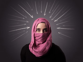 Young muslim woman wearing niqab with white arrows pointing to her head 