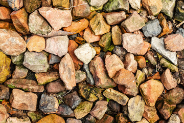 Scattered multi-colored stones for modern background texture and graphic use.
