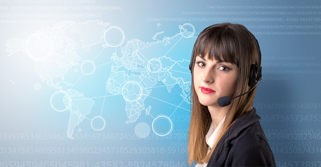 Young female telemarketer with blue background and world map and numbers behind her