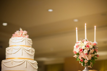 wedding cake in beach wedding. beautiful pink wedding cake. white vintage wedding cake on wooden table, outside, black background. 