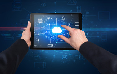 First person view of a hand using tablet with cloud office concept
