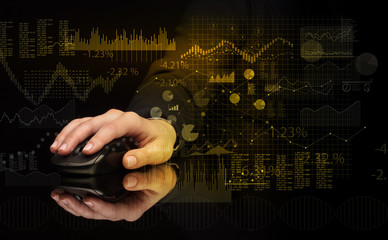 Hand using wireless mouse with financial concept on dark background
