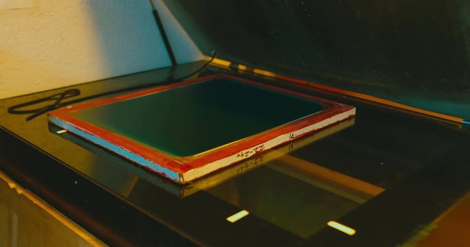 Silk screen printing process - forming a stencil from a screen with of a piece of mesh stretched over a frame. 4K UHD