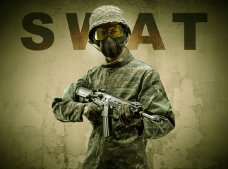 Uniformed armed soldier with damaged wall background
