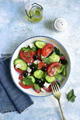 Vegetable salad with feta cheese and olive oil.Top view with copy space.