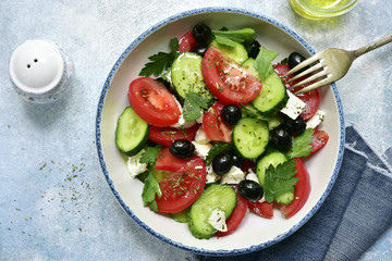 Vegetable salad with feta cheese and olive oil.Top view with copy space.