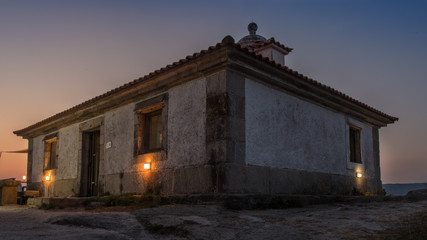  Illuminated lighthouse over the sea and the coast of Galicia © jesus