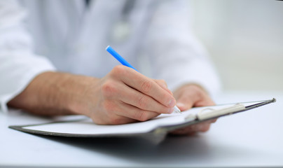 doctor writing out the prescription.close-up