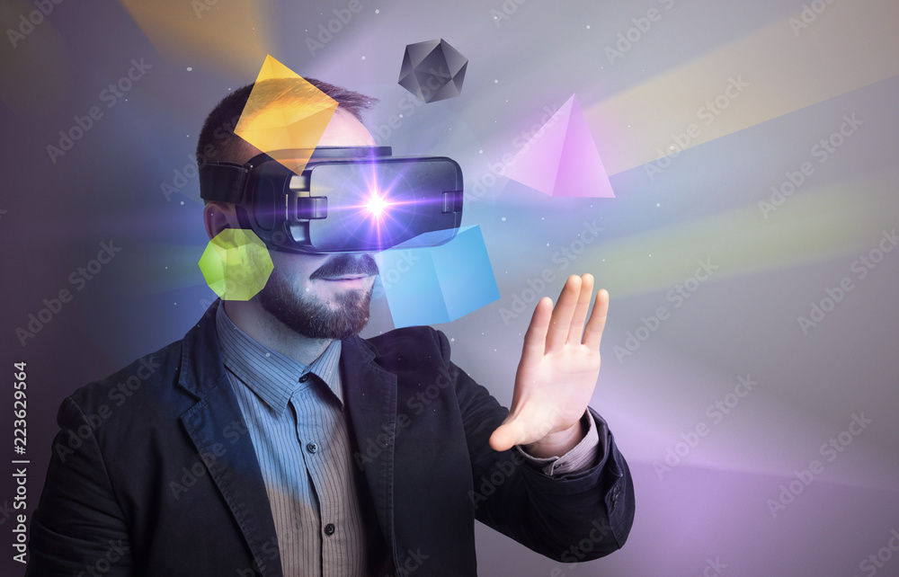 Poster amazed businessman with virtual reality colorful geometric shapes in front of him