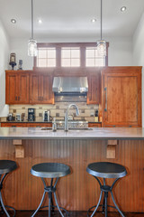 Lovely kitchen with wood cabinets and mosaic backsplash.