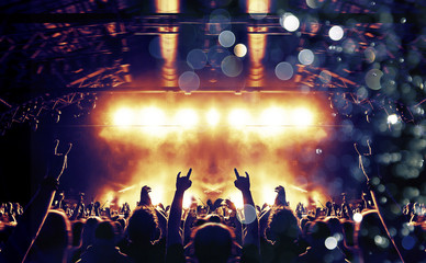 Concert hall with colourful lights and clapping people