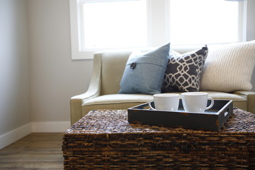 Rattan trunk coffee table with a wood tray and white cups