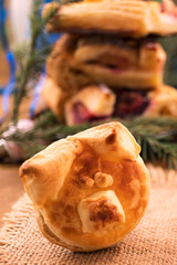 Symbol 2019-puff pastry pig on a linen napkin, vertical frame.