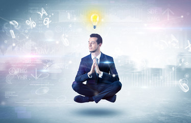 Businessman meditates with enlightenment data reports and financial concept
