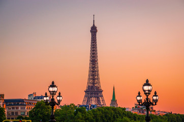 Sunset view of  Eiffel Tower and Alexander III Bridge in Paris, France.