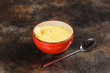 Bowl of wheat porridge and spoon, tasty breakfast