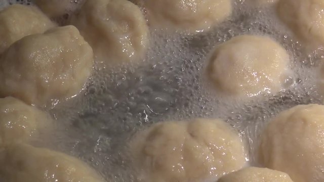 Close up cooking fruit dumplings in a pot