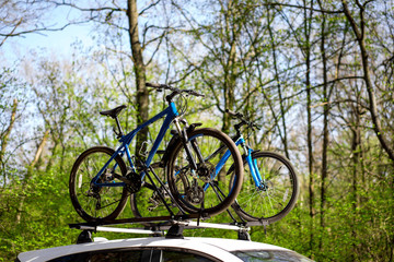 Two bikes blue mount car roof