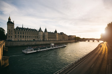 Fototapeta na wymiar Tourist boat tour on Seine river with beautiful sunset in Paris . Cruise ship sightseeing along river in Paris, France.
