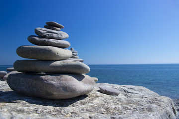 Beach stones by the sea in the summer time