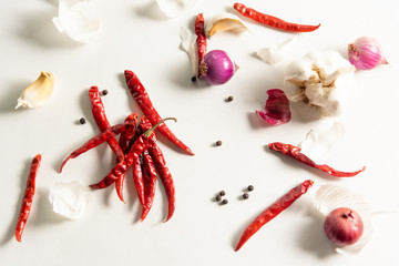 dry cayenne pepper,garlic,shallot ingredient on table 