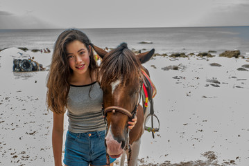 Teenager with horse on beach