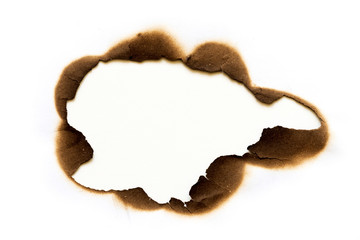 burned hole on piece of paper isolated on white background.