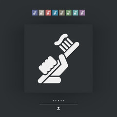 Hand holding toothpaste and toothbrush