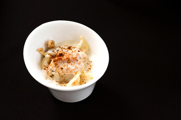 tagliatelle macaroni with cheese and basil on a wooden table. top view. pasta to take out in box.
