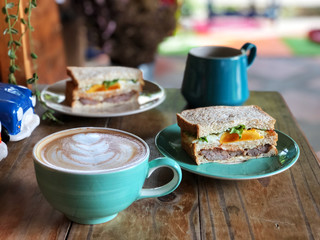 Healthy Breakfast with Homemade fresh sandwich and coffee cup on green plate set.