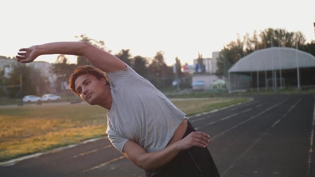 Mixed race man athlete stretching for warming up before running or work out