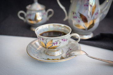 Still life with coffee in light porcelain on a dark background.