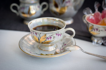 Still life with coffee in light porcelain on a dark background.