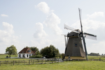 Fototapeta na wymiar Historical windmill, in the meadow
