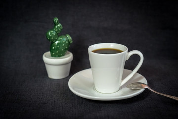 Still life with coffee in light porcelain on a dark background.