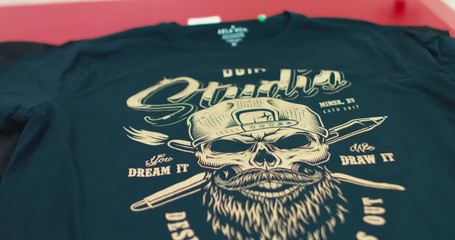 Silk screen printing process - making a print on a t-shirt. 4K UHD