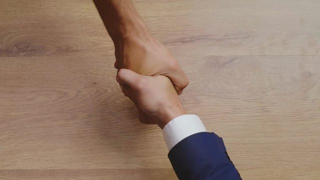 Top view of man giving a bribe and striking a deal.