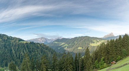 Obraz premium panorama Dolomite mountain landscape in Alta Badia with green valleys and forests and mountain peaks behind