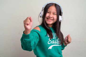 Portrait of young cute Asian girl wearing stylish clothes