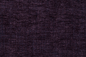 Dark purple background of soft, fleecy cloth. Texture of textile closeup