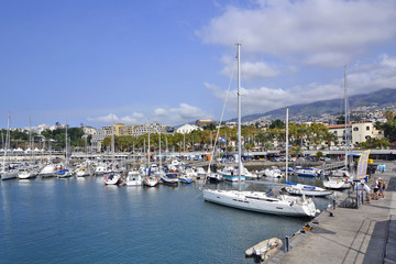 Fototapeta na wymiar Sailing boats docked in the harbor on a sunny day, Funchal, Madeira Island