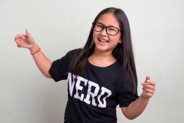 Young cute Asian nerd girl wearing eyeglasses