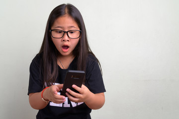 Young cute Asian nerd girl wearing eyeglasses