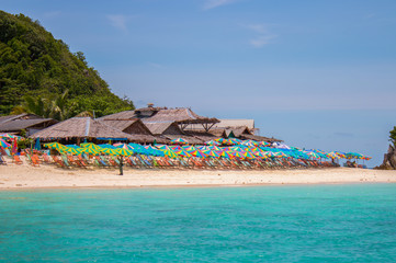 Colorful sunshade and chairs on beach in Phuket
