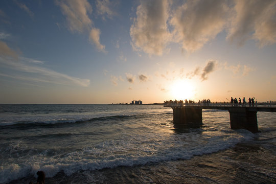 Sunset over the walking pier at the Galle Face beachfront urban park area in Colombo Sri Lanka Asia
