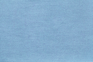 Light blue background from a textile material with wicker pattern, closeup.