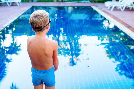 boy afraid expects before jump in swimming pool