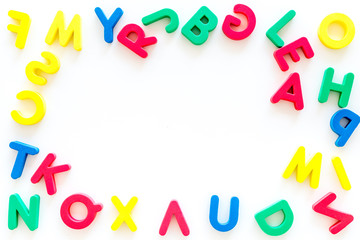 Alphabet for kids concept.  English letters in disorder on white background top view copy space